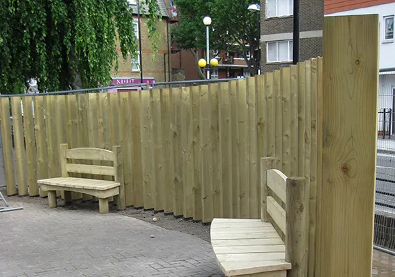 Commercial timber fencing with built-in wooden bench