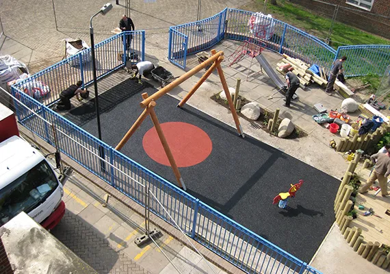 Children's playground with safety surfacing and swing set